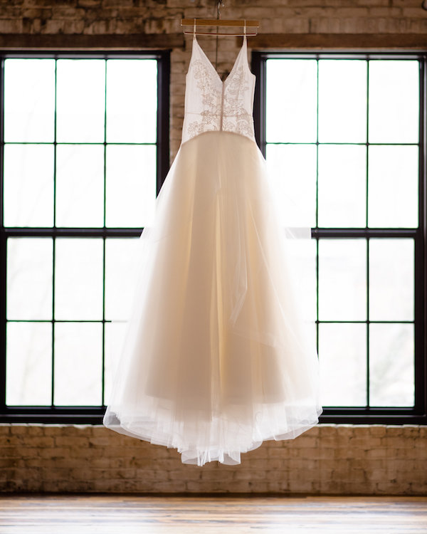 Wedding gown hanging up before a Journeyman Distillery wedding