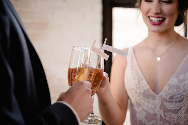 A couple sharing a glass of champagne during a Journeyman Distillery wedding