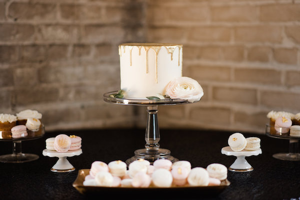 A gold wedding cake with french macarons 