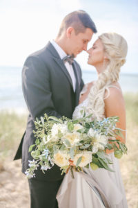 White and green bridal bouquet with bride and groom in South Haven, Michigan