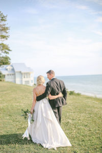 Bride and groom walking towards Lake Michigan