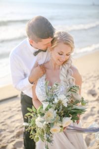 Bride and groom smiling on the beach of Lake Michigan