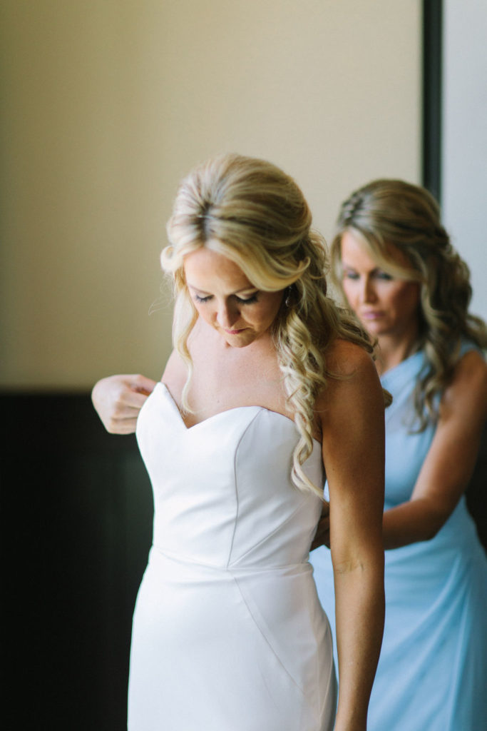 Maid of Honor helping a bride get dressed the morning of her wedding in Benton Harbor, MI