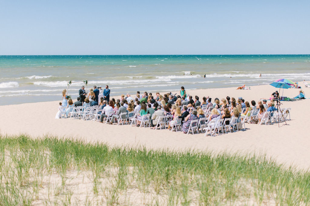 ceremony happening during beach wedding in michigan