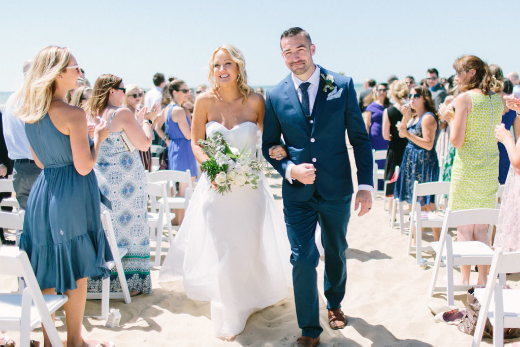 Bride and groom recessing after their Lake Michigan beach ceremony