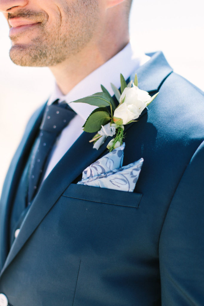 Groom's boutonnière on a navy blue suite 