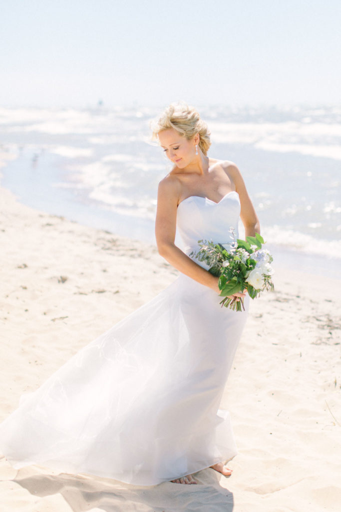 Bride stands next to Lake Michigan 