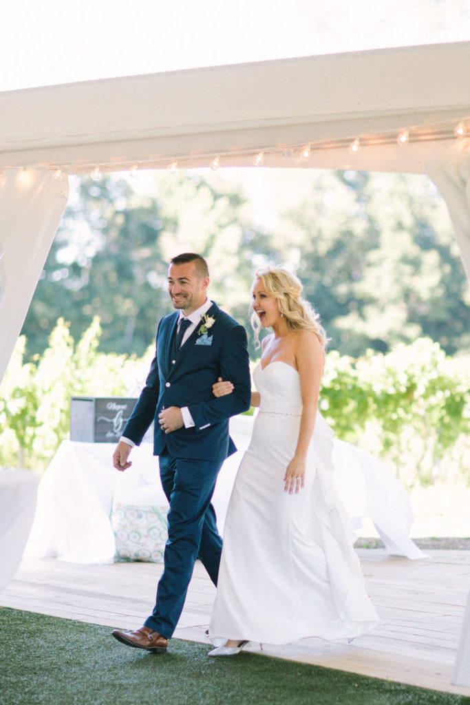 Couple walking into the wedding tent at a 12 Corners Vineyard Wedding