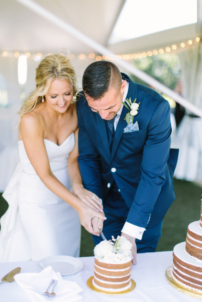 Couple cutting their cookie cake at their 12 Corners Vineyard Wedding