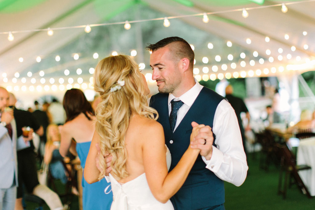 Couple sharing a last dance under string lights at a 12 Corners Vineyard Wedding