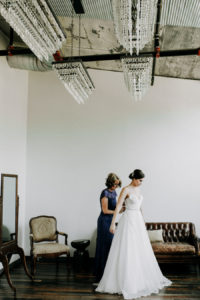 Bride gets dressed at her Journeyman Distillery wedding