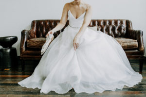 Bride putting on her shoes at Journeyman Distillery