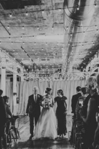 Bride walking down the aisle at a Journeyman Distillery wedding