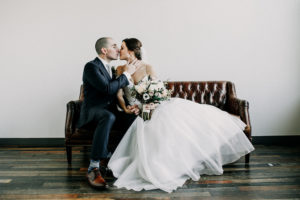 Bride and Groom kissing in the bridal suite at a Journeyman Distillery wedding