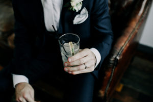 Groom enjoying a cocktail at his Journeyman Distillery wedding