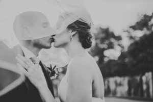 Bride and groom kissing outside at their Three Oaks, Michigan wedding