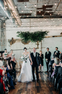 Couple walking down the aisle at a Journeyman Distillery wedding