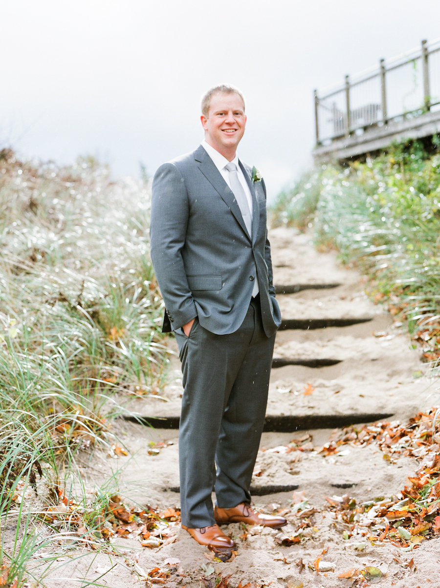 Groom smiling before his camp blodgett wedding