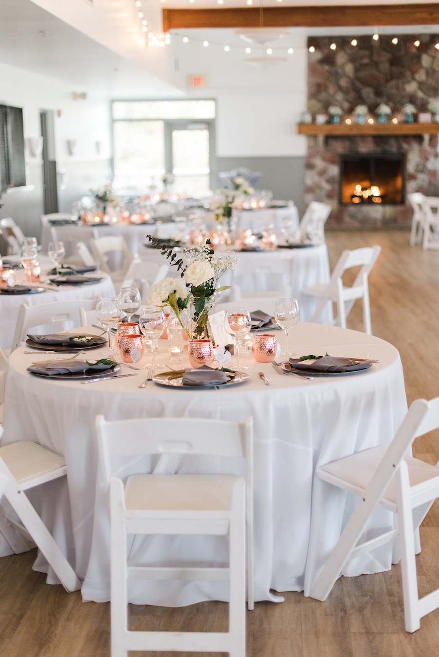 Tables set up inside at a camp blodgett wedding