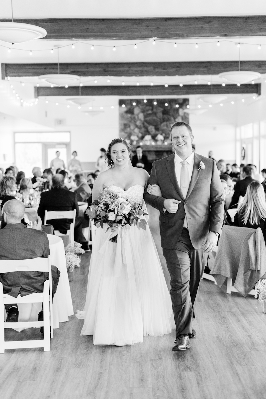 Newlyweds walking down the aisle at a camp blodgett wedding