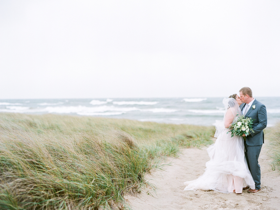 Newlyweds kissing at a camp blodgett wedding