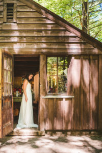 Bride gets dressed in the craft cabin at Long Lake Outdoor Center Wedding
