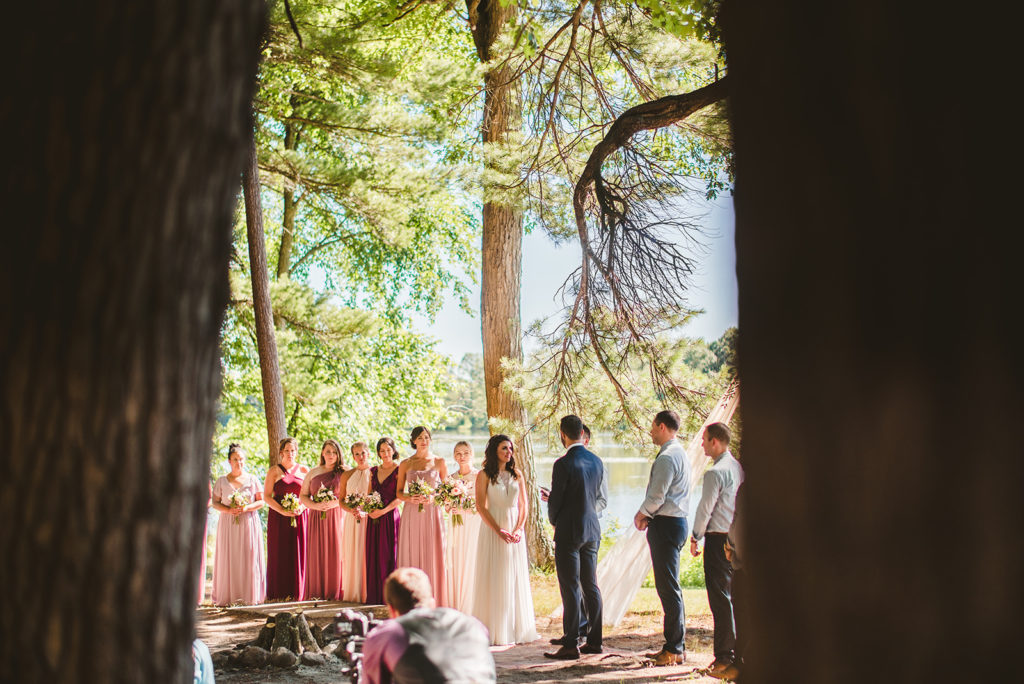 A ceremony in the woods during a Long Lake Outdoor Center wedding