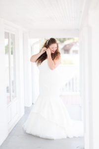 Bride getting dressed before her lakeside wedding