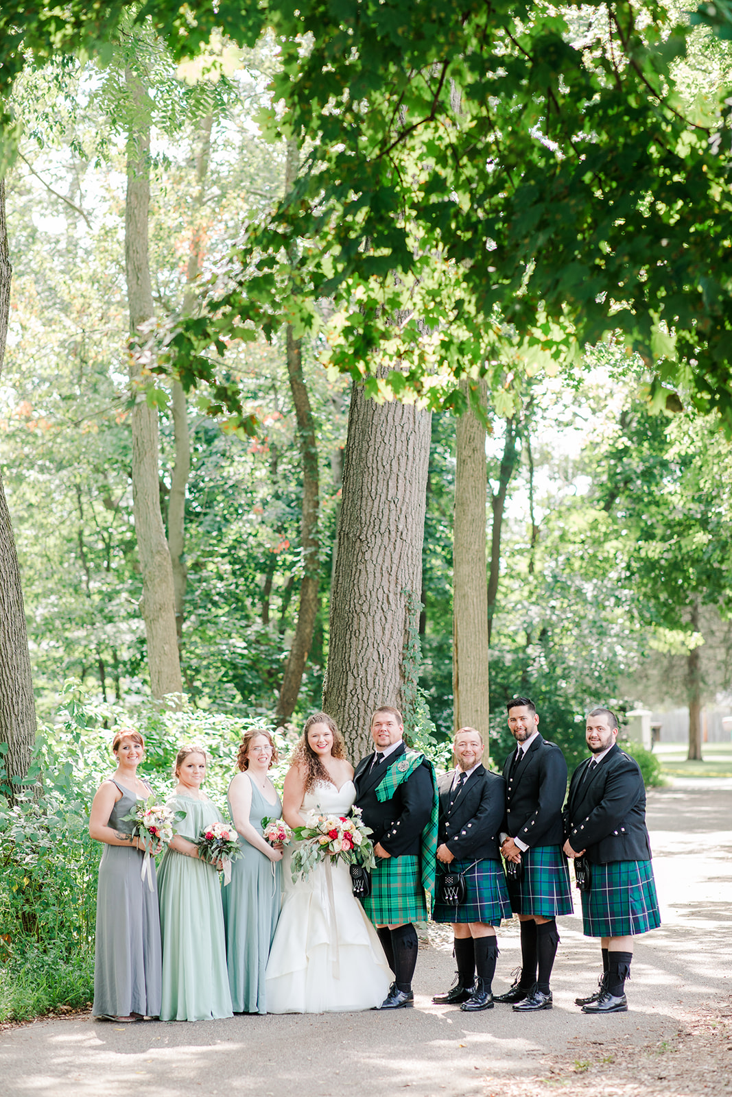 Bridal party smiling before a lakeside wedding 