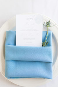 Dinner menus with blue napkins