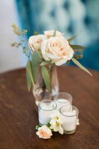 Bud vases on an end table at a wedding