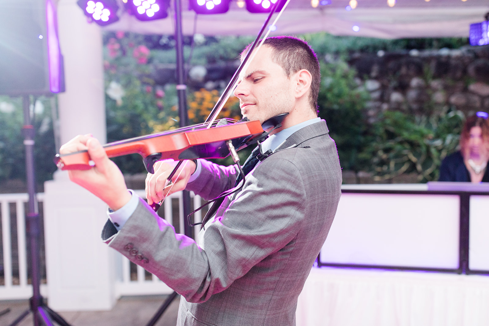 Violinist playing as guests dance