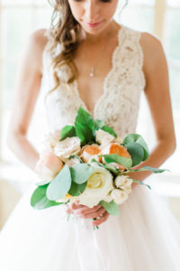 Bride smiling at her bridal bouquet before her Holland, Michigan wedding