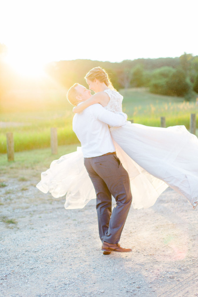 Bride and groom smiling during sunset at their felt mansion wedding