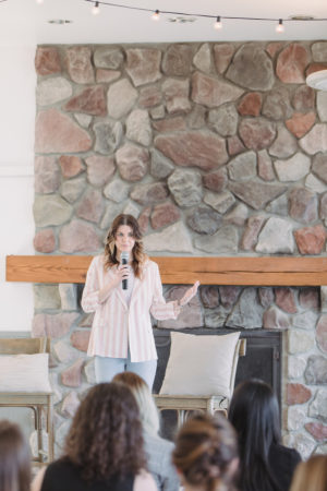 Amanda Adamcheck on stage speaking at The Haven Conference in West Olive, Michigan
