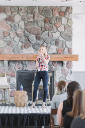 Brittney Suttle on stage speaking at The Haven Conference in West Olive, Michigan