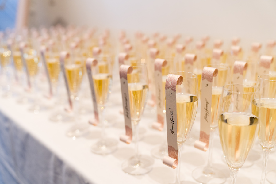 Champagne escort cards lined on a table during a Loft 310 wedding
