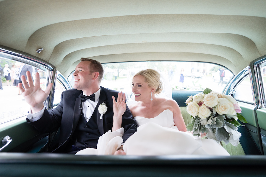 A bride and groom driving away during their Kalamazoo, Michigan wedding