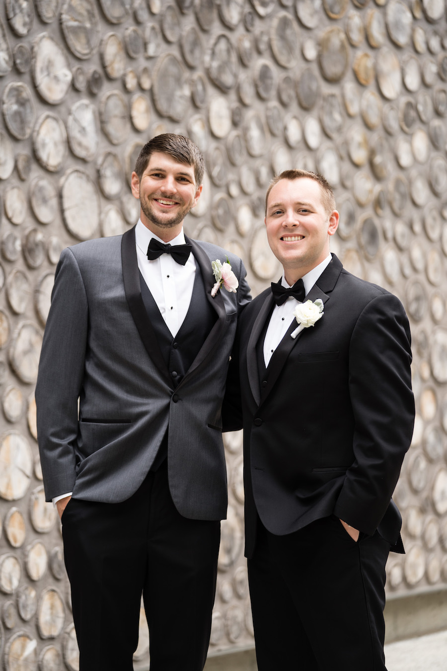 A groom and groomsman smiling before his Kalamazoo, Michigan wedding