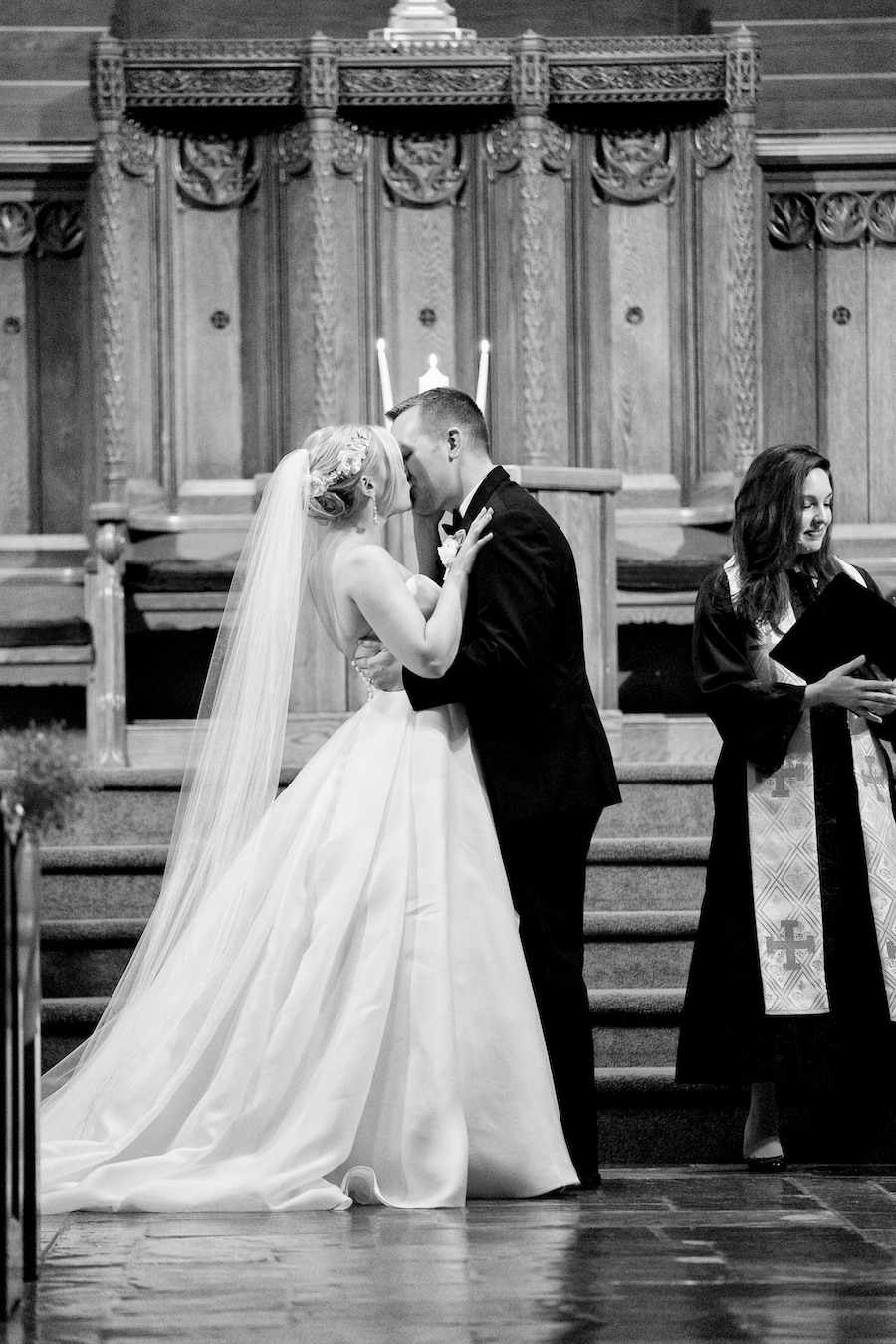 A bride and groom sharing their first kiss during their Kalamazoo, Michigan wedding
