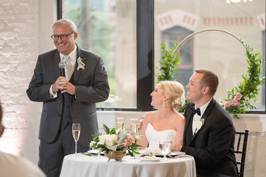 A bride and groom enjoying speeches during their Loft 310 wedding