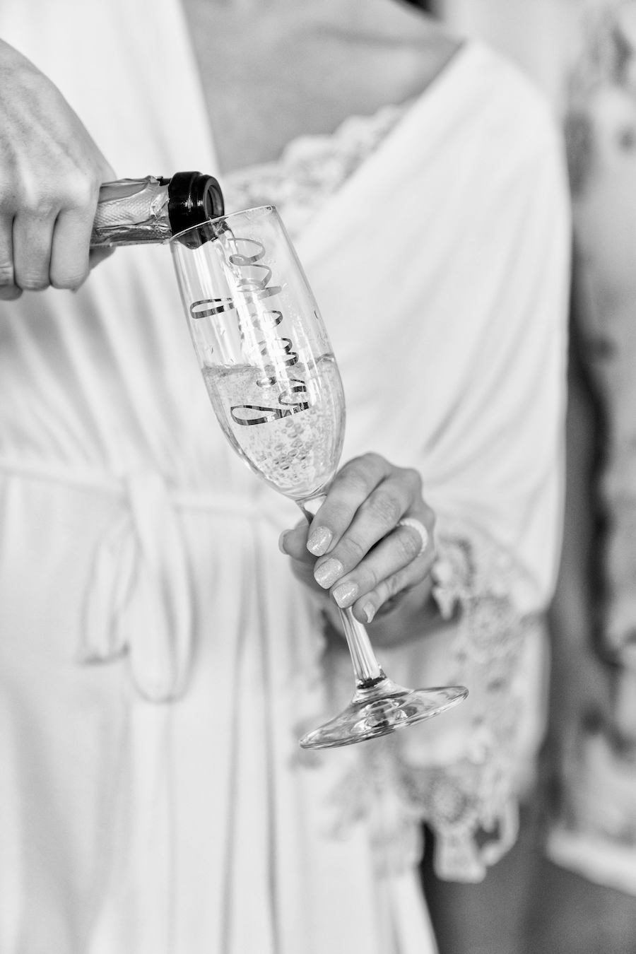 A bride pouring champagne the morning of her wedding