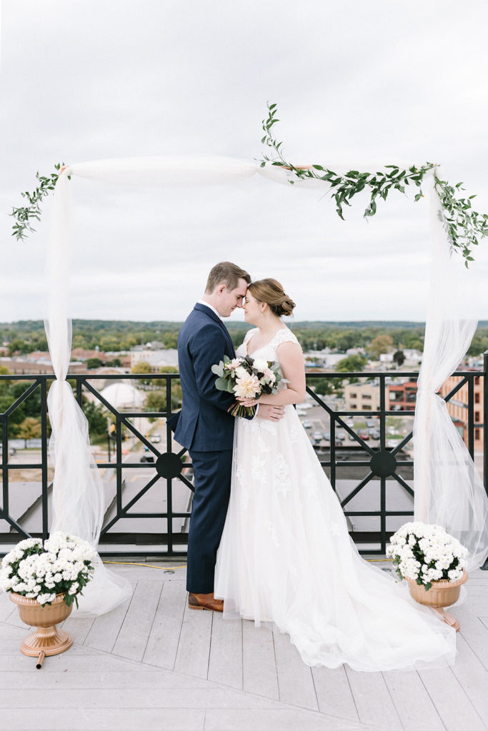A bride and groom at the alter of their Sky Deck wedding in Kalamazoo, Michigan