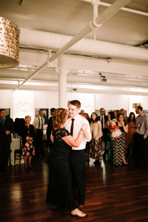 A mother and a groom share a dance during a loft 310 wedding
