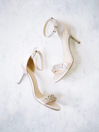 Bridal shoes laying out on a marble backdrop