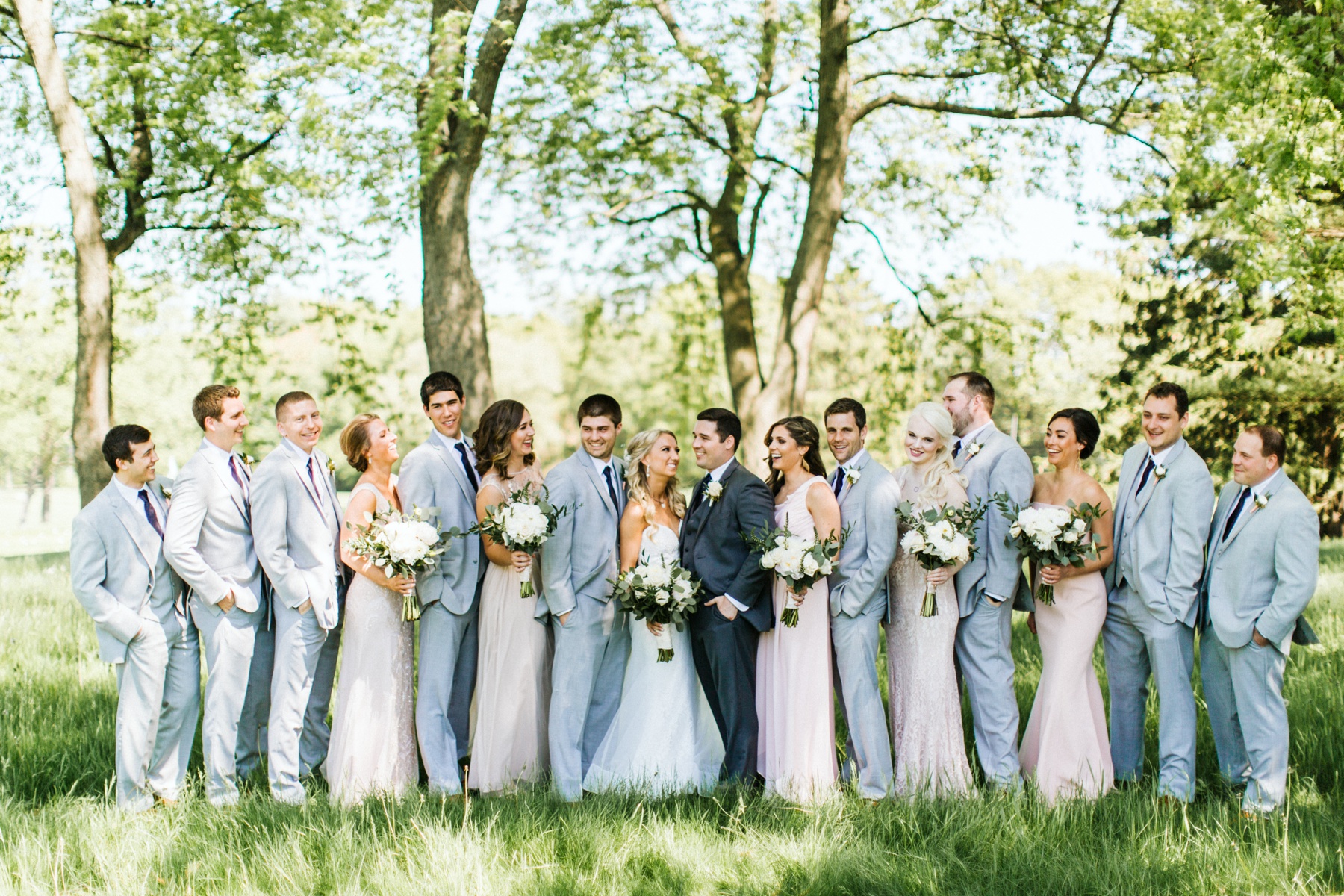 A wedding party smiling before a spring lake country club wedding