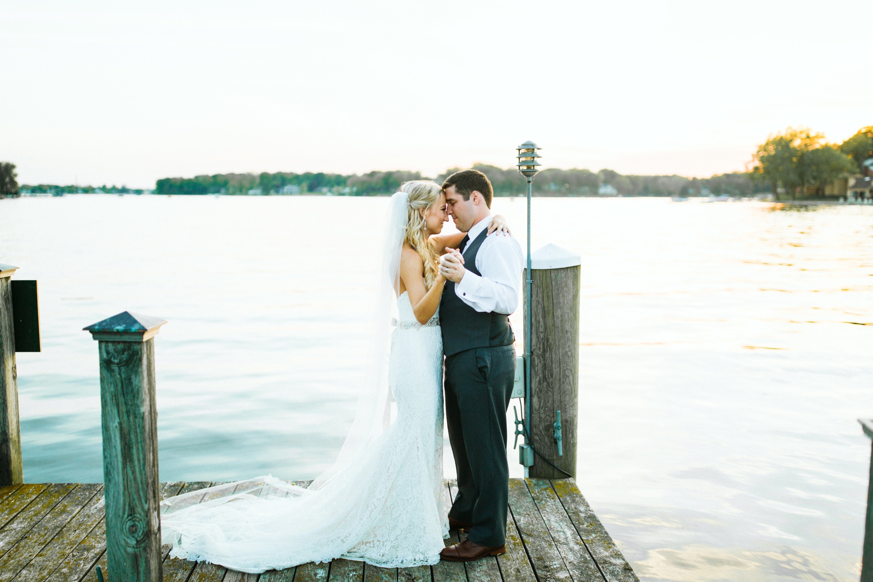 A bride and groom dancing by the lake during their Spring Lake Country Club wedding