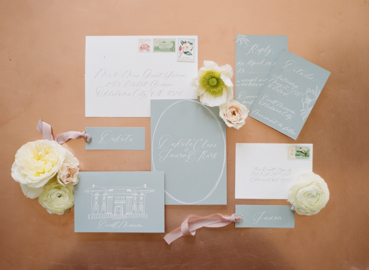 A gray and copper invitation suite