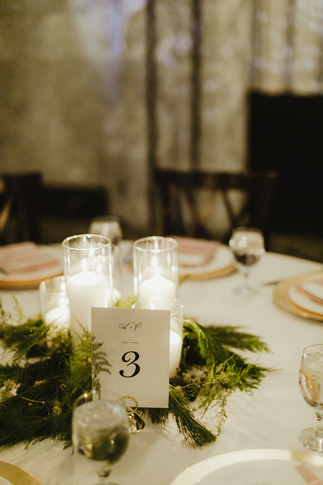 Candles and greenery on a table as wedding decor