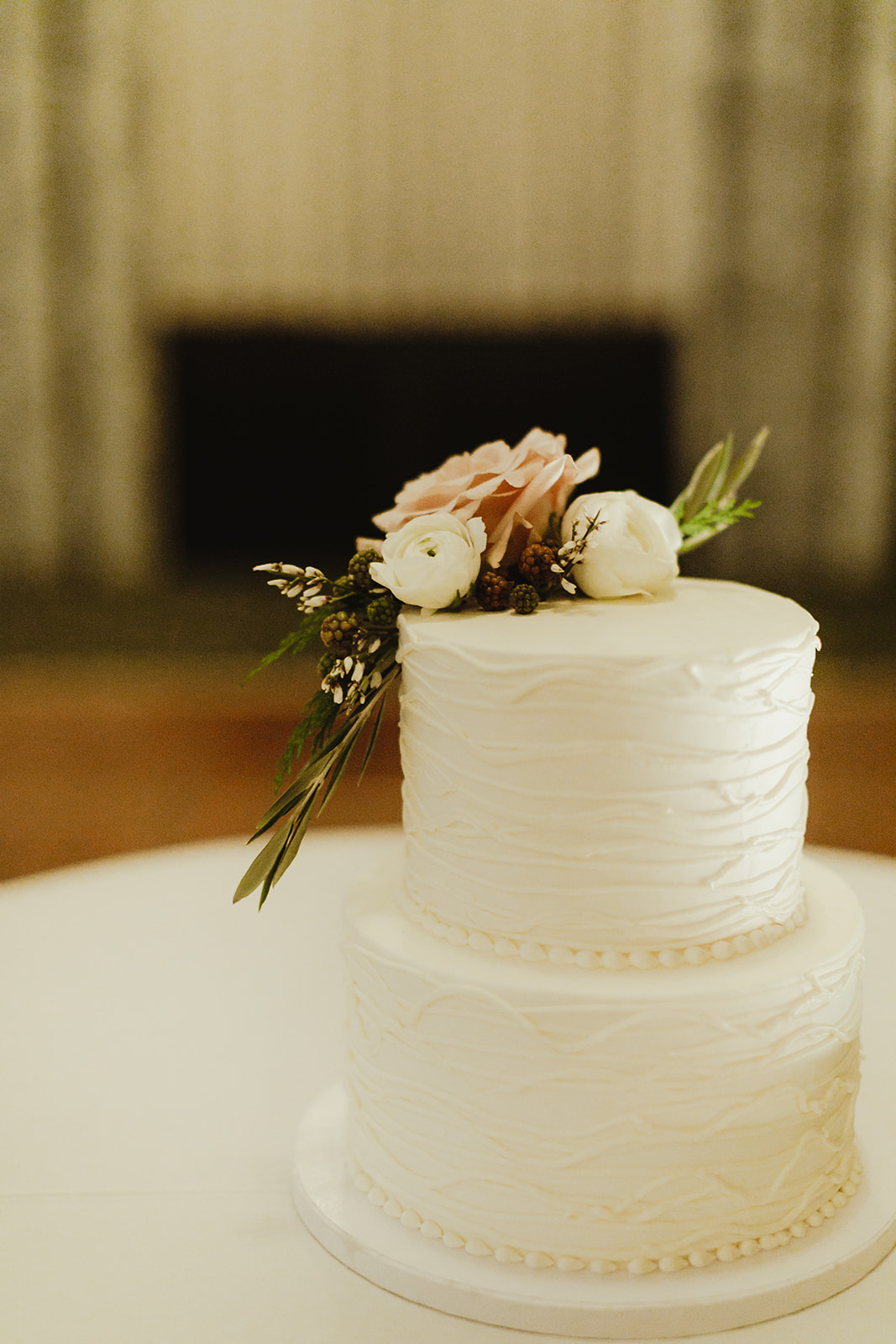 A white wedding cake with flowers on it